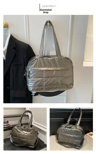 Detail of gunmetal quilted fitness bag featuring metallic finish and dual strap options