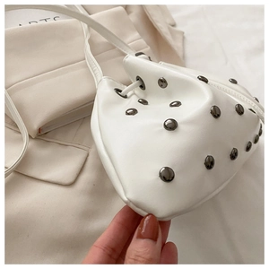 Detail of white heart-shaped bucket bag with silver metal rivets and drawstring
