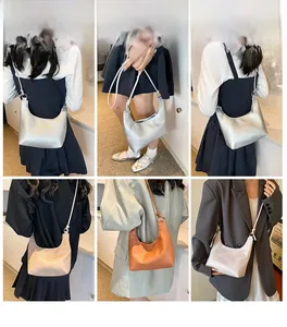 Detail view of the crescent underarm bag showing silver, orange, and beige color options