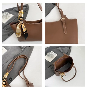 Detail view of brown tote bag with white stitching, silk scarf handle, and interior pocket