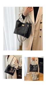 Detail view of black quilted tote bag with gold chain strap and buckle closure