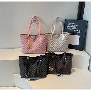 Detailed display of tote bags in pink, beige, black, and brown with all-over M-print pattern