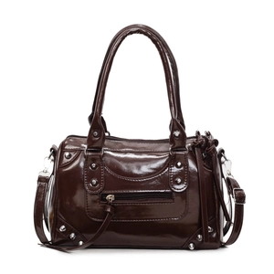 Dark brown patent leather pillow crossbody bag with silver studs and polished finish