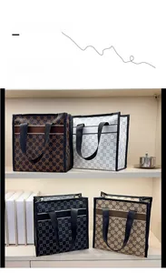 Close-up of stylish tote bags in various patterns including monogram and geometric prints