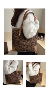 Detail of leopard print tote bag showing leather strap and gold rivet reinforcement