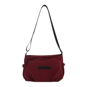 Burgundy water-resistant nylon crossbody bag with multi-pockets and adjustable strap