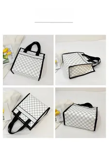 Detail showing monochrome geometric flower pattern and black trim on a stylish tote bag