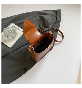Internal structure of brown glossy faux leather shoulder bag with functional compartments
