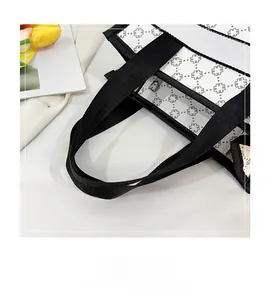 Detail of reinforced woven handle and geometric print texture on stylish tote bag