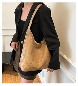 Close-up of khaki retro tote bag featuring premium crocodile pattern and hobo design