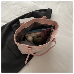 Inside view of a pink lace tote bag showing storage for a tablet, wallet, and phone
