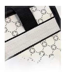 Macro view of reinforced stitching and geometric insect pattern on large tote bag
