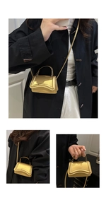Detailed views of gold mini handbag with wavy base and versatile shoulder strap