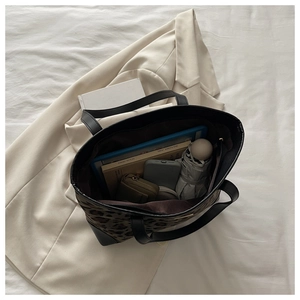 Spacious leopard print tote bag interior showing capacity for tablets, books, and essentials