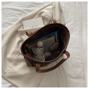 Top view of spacious leopard print tote bag interior with daily essentials and tablet