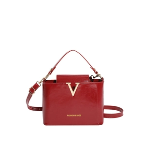 Red crocodile texture shoulder bag with gold V clasp and fashion lettering on front