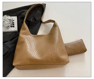 Detail shot of brown woven texture tote bag and matching inner pouch set