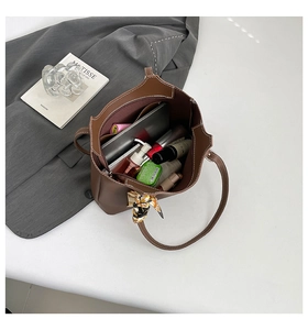 Interior detail of large brown leather tote bag showing spacious storage for tablet and makeup