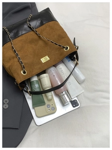 Detail view of contrast quilted bucket bag showing large capacity for essentials