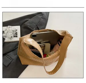 Macro detail of spacious woven leather tote bag showing capacity for daily essentials