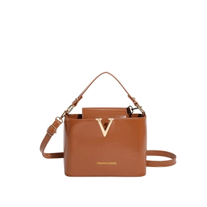 Brown glossy leather crossbody bag with gold V-metal decor and adjustable strap