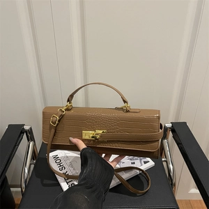 Brown crocodile embossed baguette bag with gold twist lock and slim shoulder strap