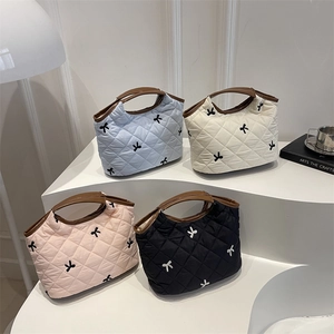 Quilted tote bags with bow embroidery and leather handles in four elegant colors