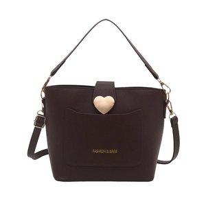 Brown leather bucket bag with gold heart buckle and adjustable strap shown on white background
