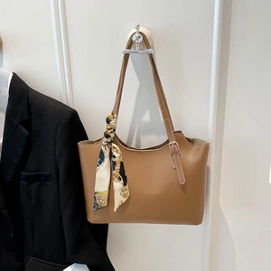 Brown faux leather tote bag with vintage printed scarf on handle for office commuting