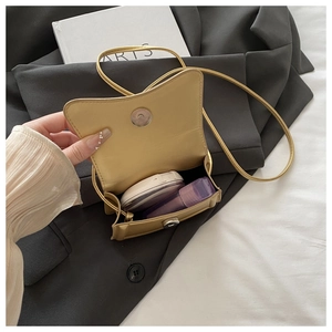 Interior view of mustard yellow mini crossbody bag showing storage for makeup products