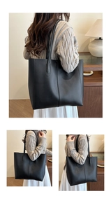Detailed view of a black matte leather tote bag with elegant decorative central stitching