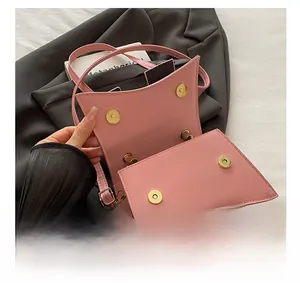 Detail of pink hourglass shoulder bag showing internal golden magnetic snap buttons