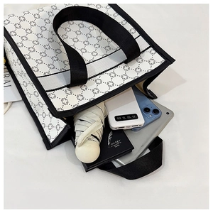 Top view of cream tote bag with black geometric patterns showing spacious inner storage