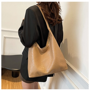 Detailed view of woven texture on a brown large capacity leather tote bag