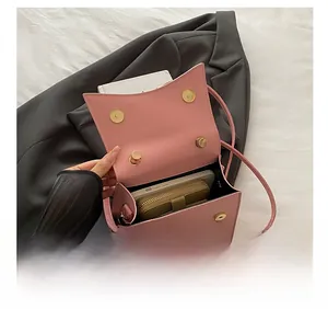 Pink leather crossbody bag interior showing storage space for phone and wallet