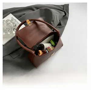 Interior view of brown leather bag showing spacious storage for cosmetics and gadgets