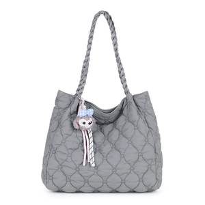 Quilted gray tote bag with woven shoulder straps and plush heart-patterned texture