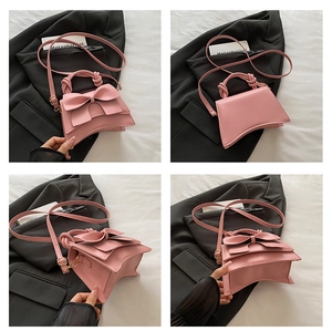 Detail view of pink bow handbag showing front, side, and base angles with gold hardware