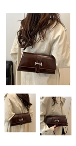 Detail view of coffee hobo bag with silver buckle on a stylish beige trench coat