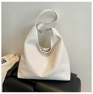 Detailed view of white woven texture and magnetic clasp on high-capacity hobo bag