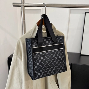 Monochrome pattern tote bag with black woven handles for daily commute and casual style