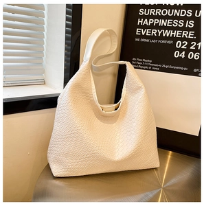 Close-up of the woven texture and premium white synthetic leather on large tote bag