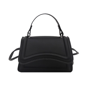 Minimalist black matte leather small square bag with curved bottom and wavy flap