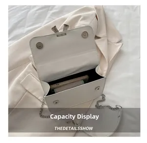 Internal capacity of the cream leather crossbody bag showing space for phone and makeup