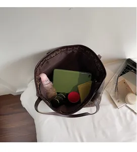 Detail view of large tote bag interior showing spacious storage for tablet and umbrella