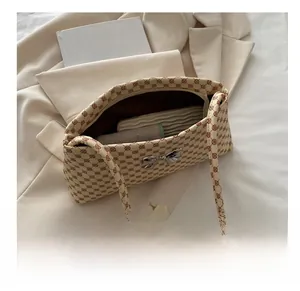 Internal storage view of beige patterned shoulder bag with silver bow buckle