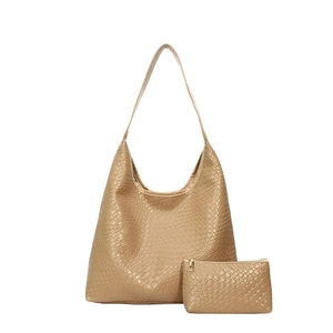 Light brown woven leather tote bag set with matching inner pouch on white background