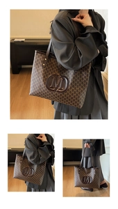Close-up of deep brown tote bag with M-letter monogram and circular embossed logo