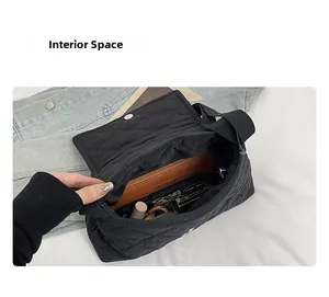 Interior view showing the large capacity of the black quilted shoulder bag for essentials