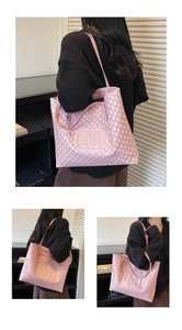 Detail of pink large tote bag with M monogram print and embossed logo on shoulder